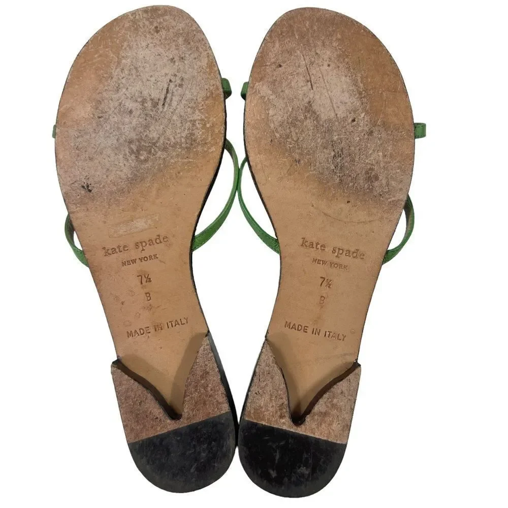 Kate Spade Green Leather Flat Sandals with wooden center ornament.